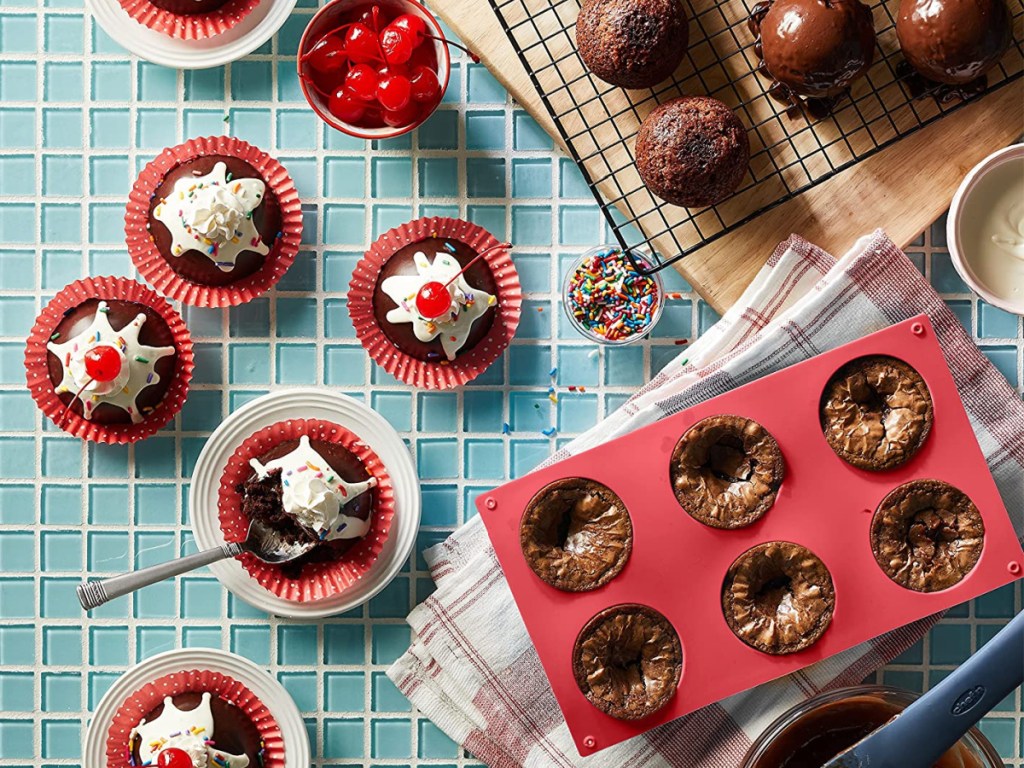 red hot chocolate bomb molds and small cakes in red baking cups