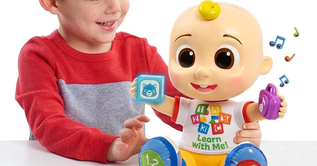 boy with cocomelon interactive jj doll