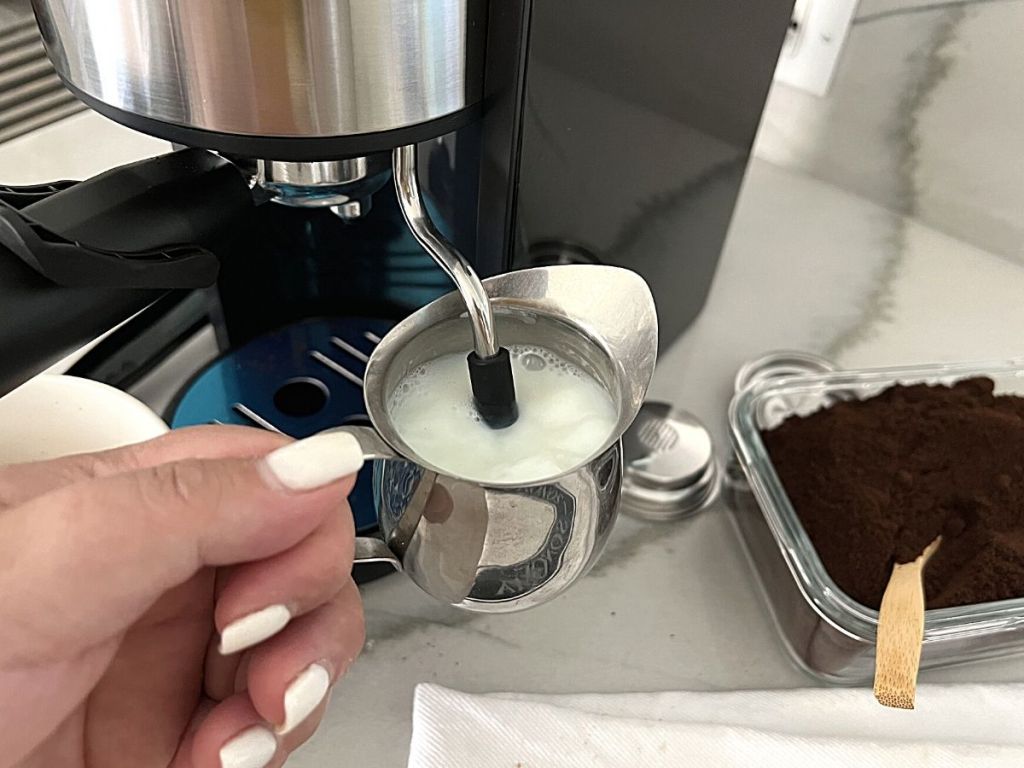 person using frother on Coffee Gator Espresso Machine