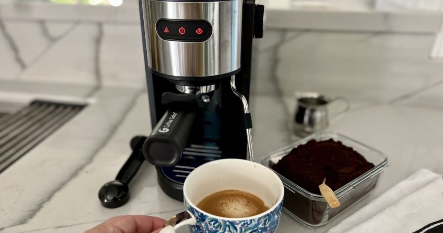 A person making a cup of espresso with a Coffee Gator Espresso Machine
