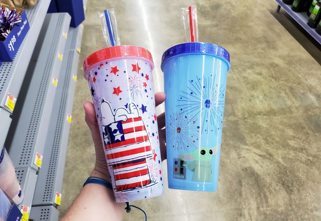 holding two color changing tumblers