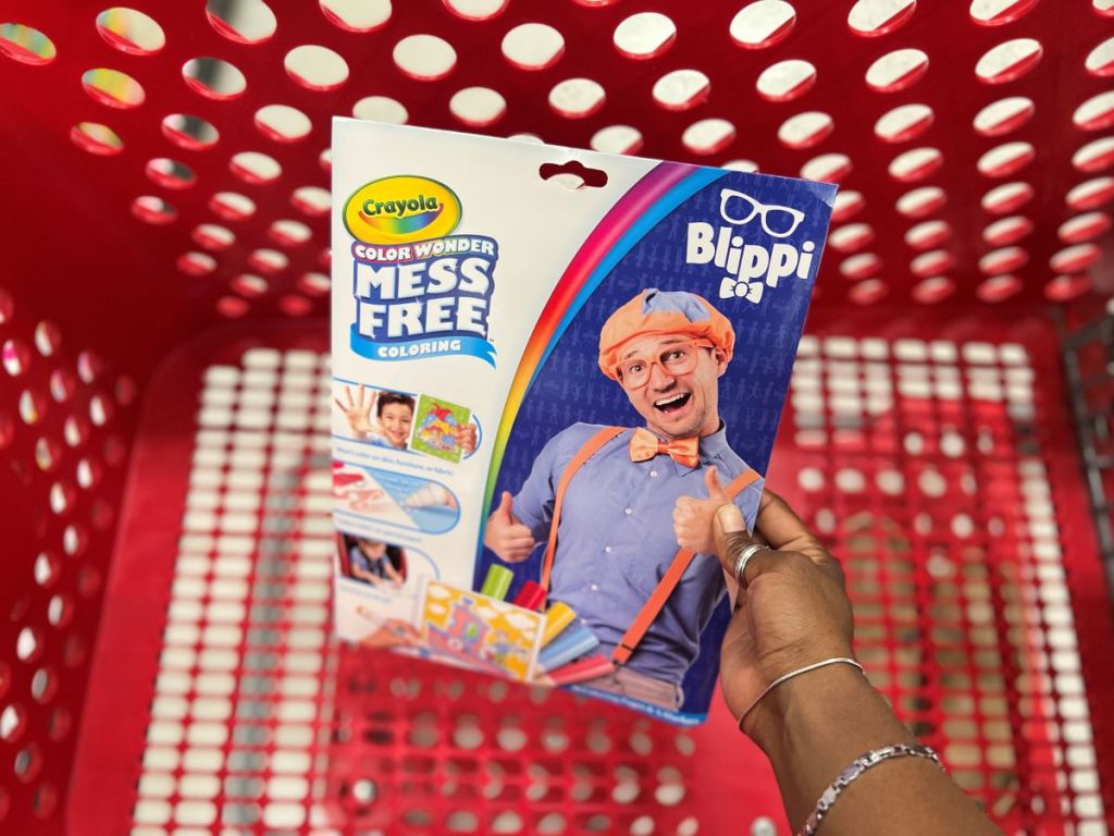 hand holding a Crayola Color Wonder Blippi by a Target cart