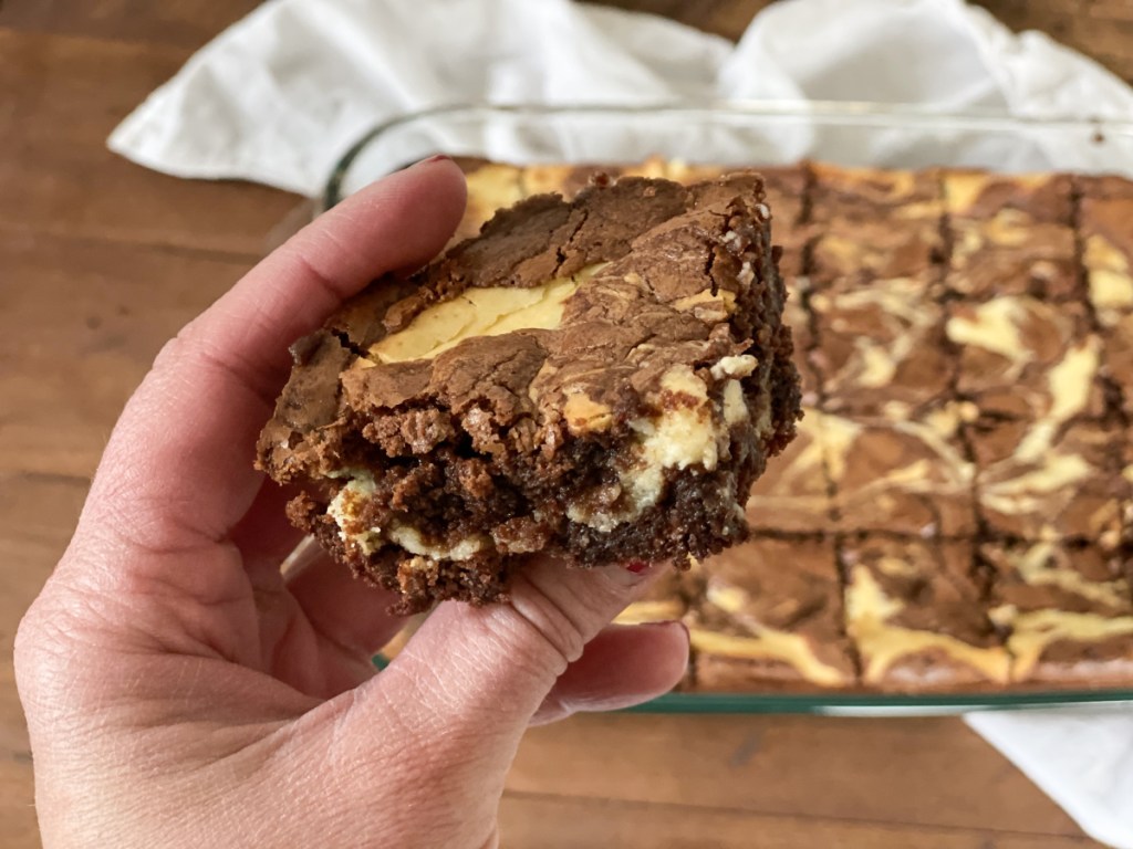 holding a cream cheese brownie