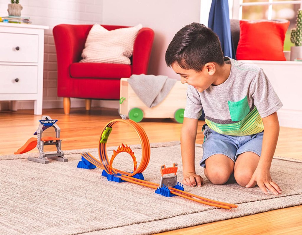 boy playing with a race car set