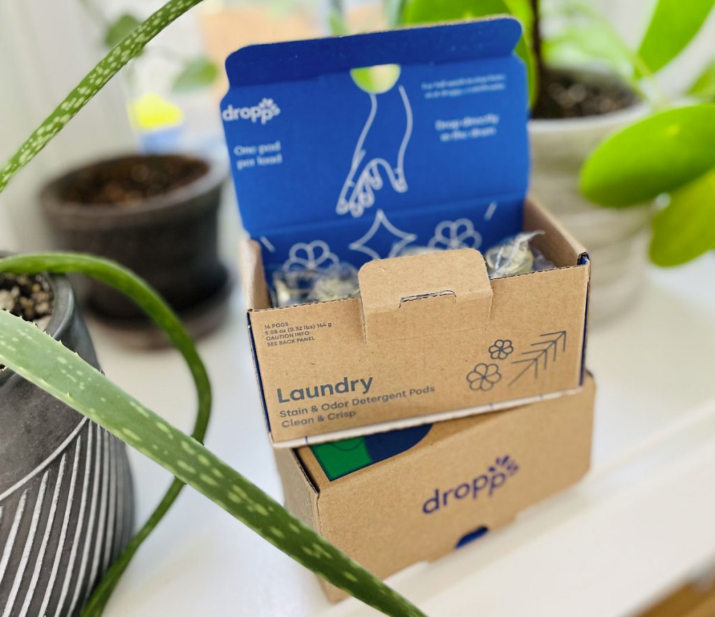 box of drops detergent pods near plant