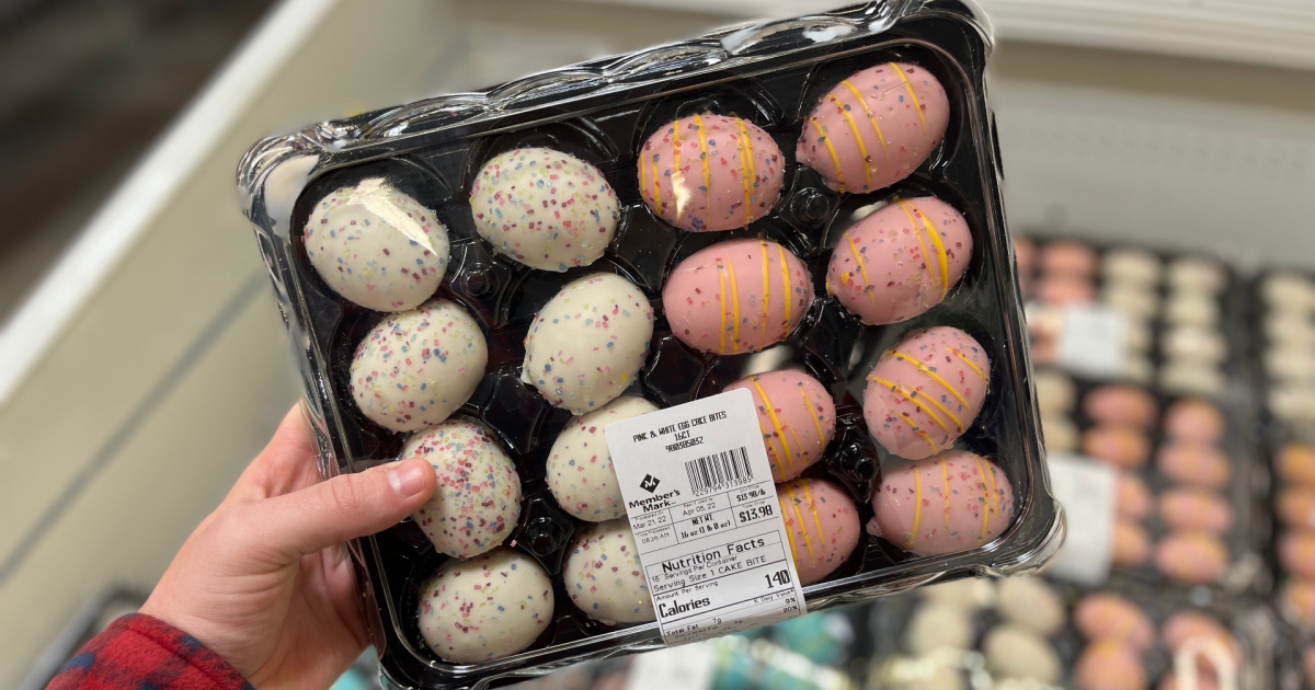 hand holding tray of white and pink Easter egg cake bites