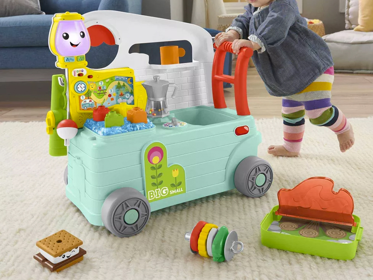 toddler playing with fisher price camper toy
