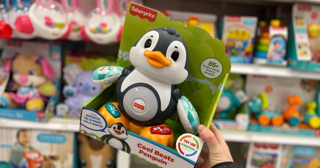 hand holding musical penguin toy 