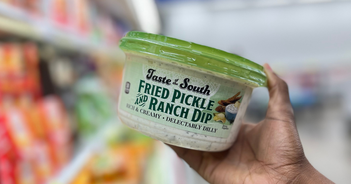 hand holding fried pickle ranch dip container