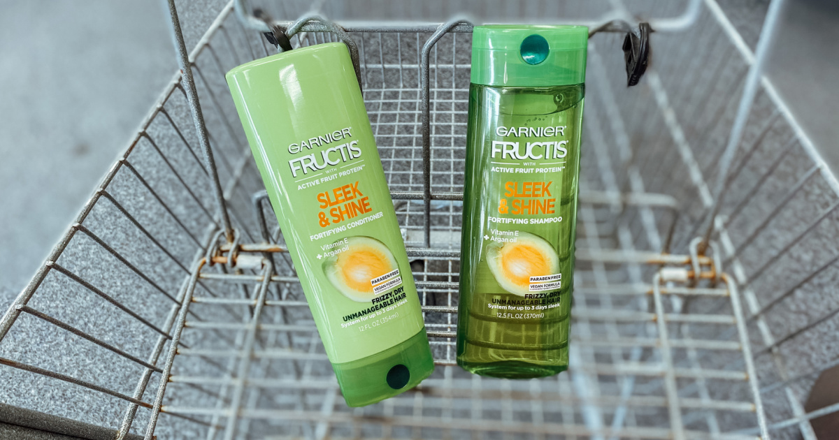 two bottles of garnier hair products - fructis shampoo and conditioner - in a walgreens cart