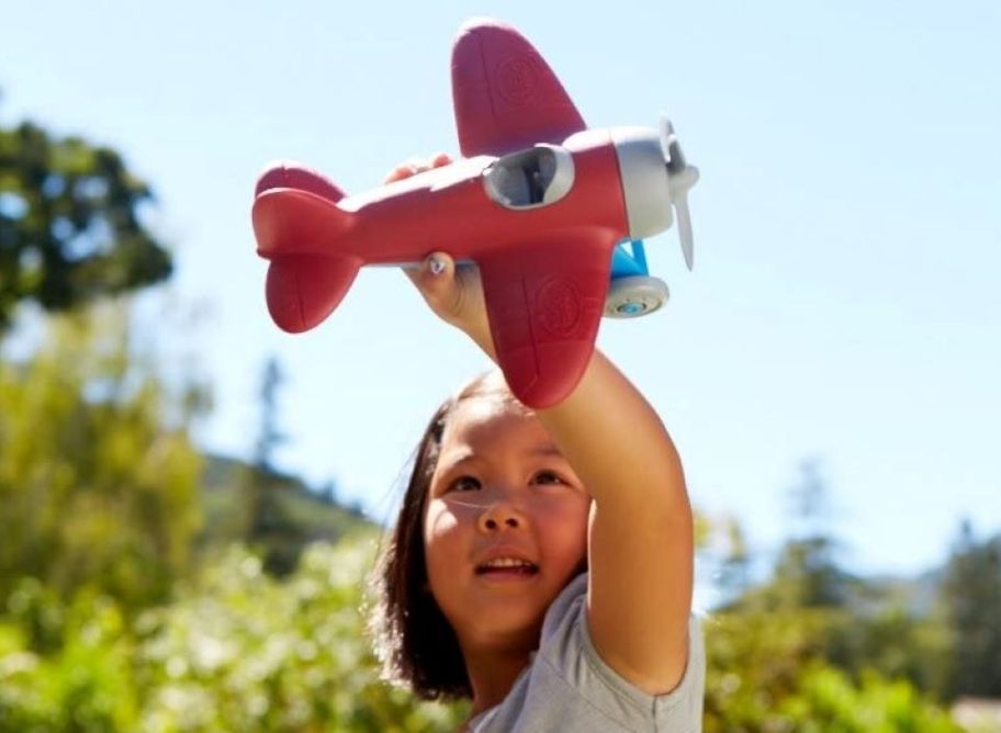 girl playing with an airplane