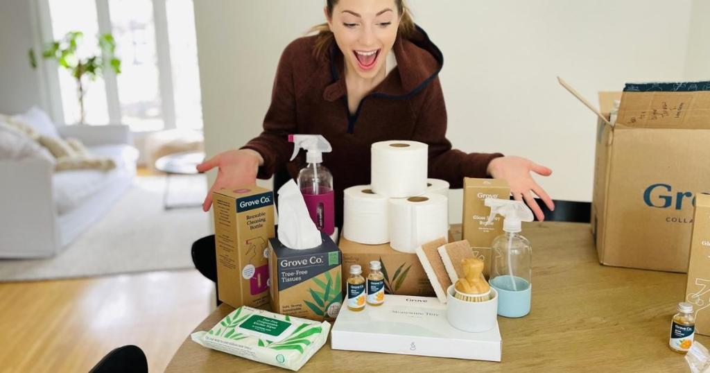 woman standing behind table full of grove collaborative products