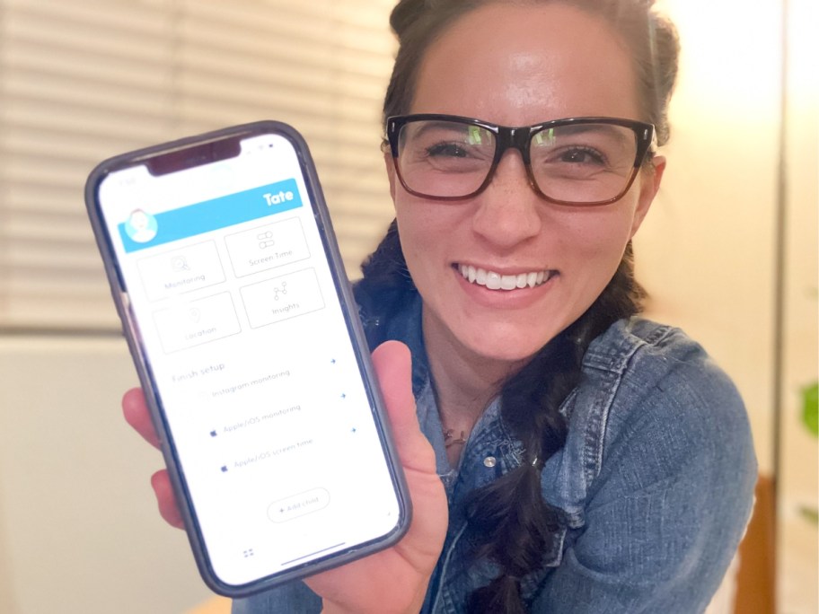 Chelsey smiling while holding a smartphone with the Bark app open showing the various options