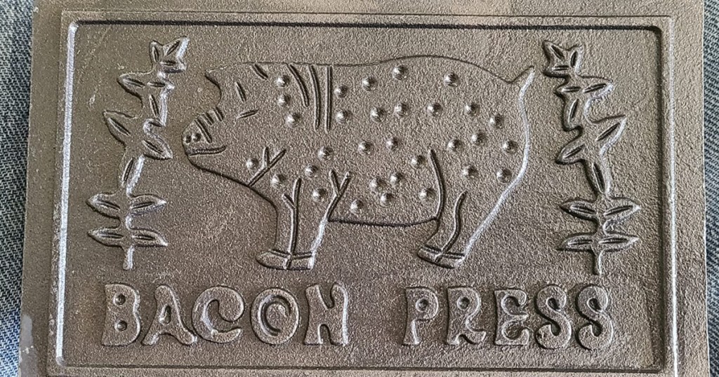piece of cast iron with image of pig on it