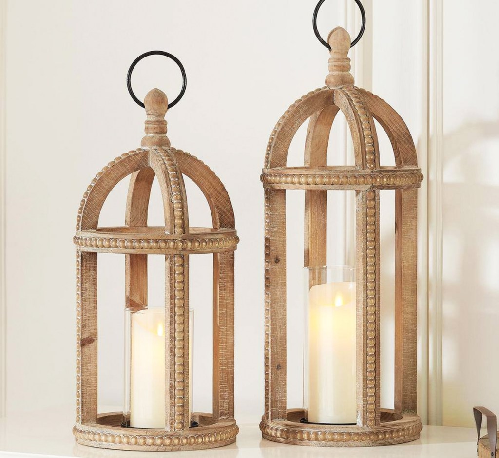 two brown wood candle lanterns with beaded accents