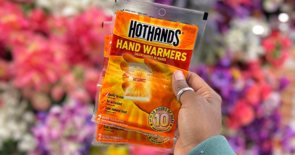 hand holding two packs of HotHands