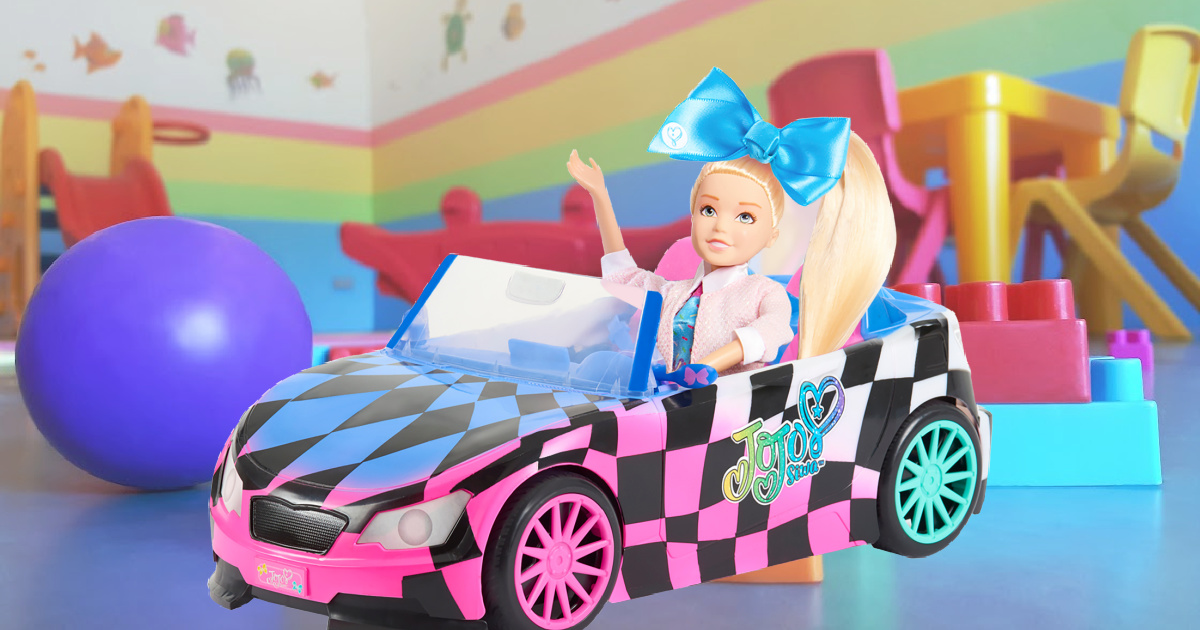 doll in toy car in playroom