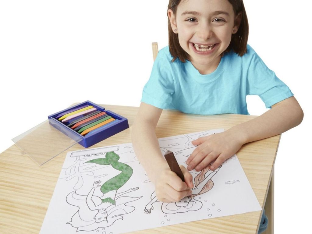 girl coloring on large coloring paper