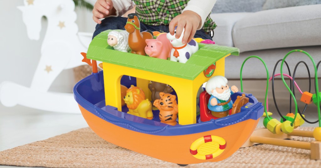 boy playing with Noah's Ark set in living room