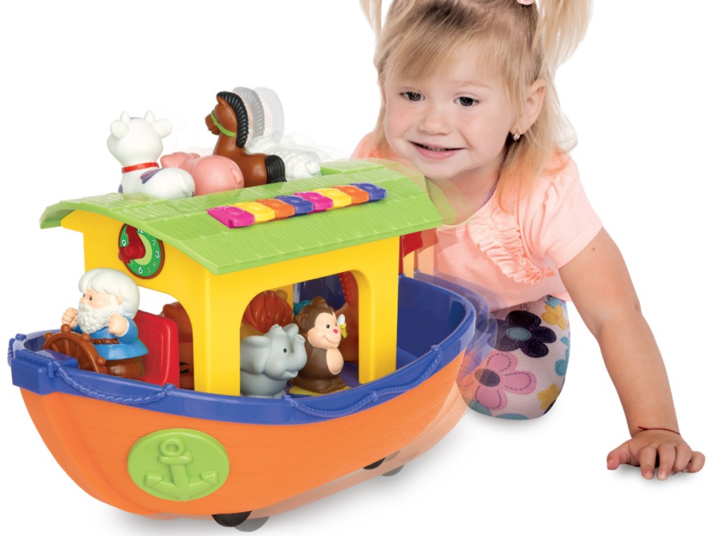 girl playing with Noah's Ark set