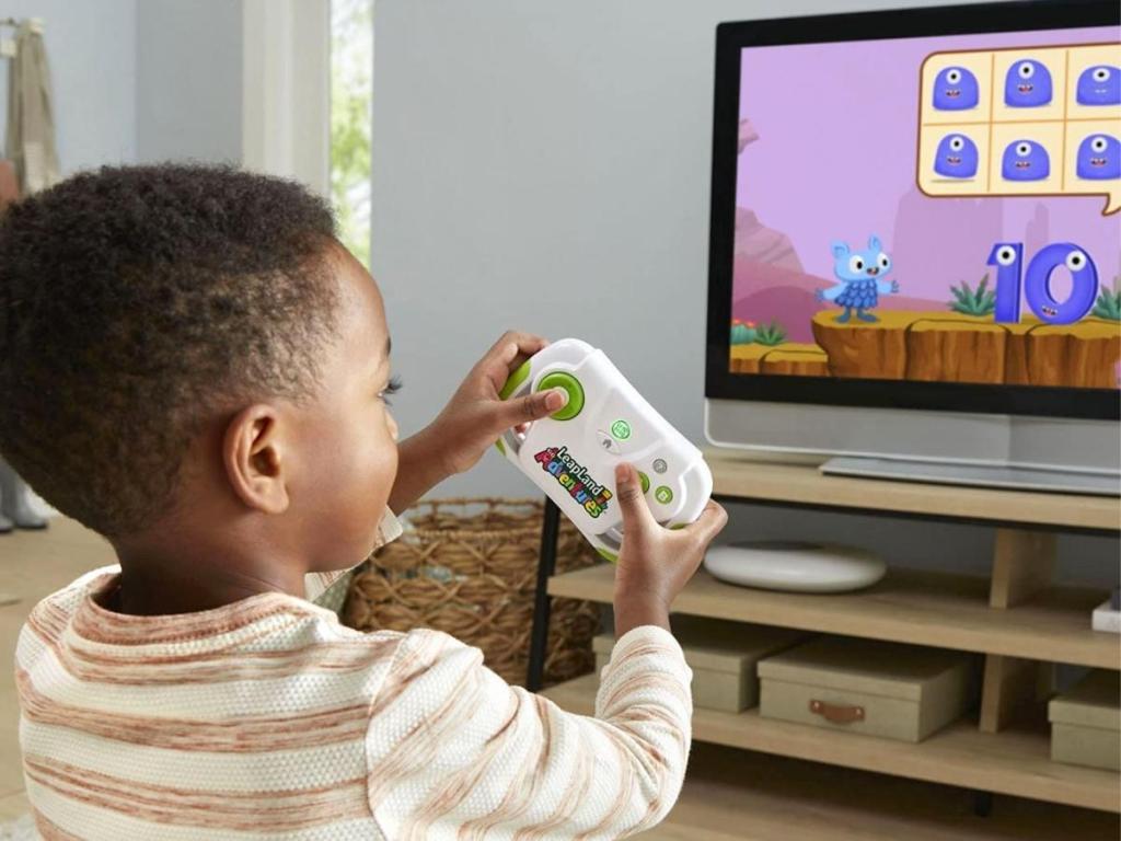 boy playing with LeapFrog LeapLand Adventures Learning Video Game