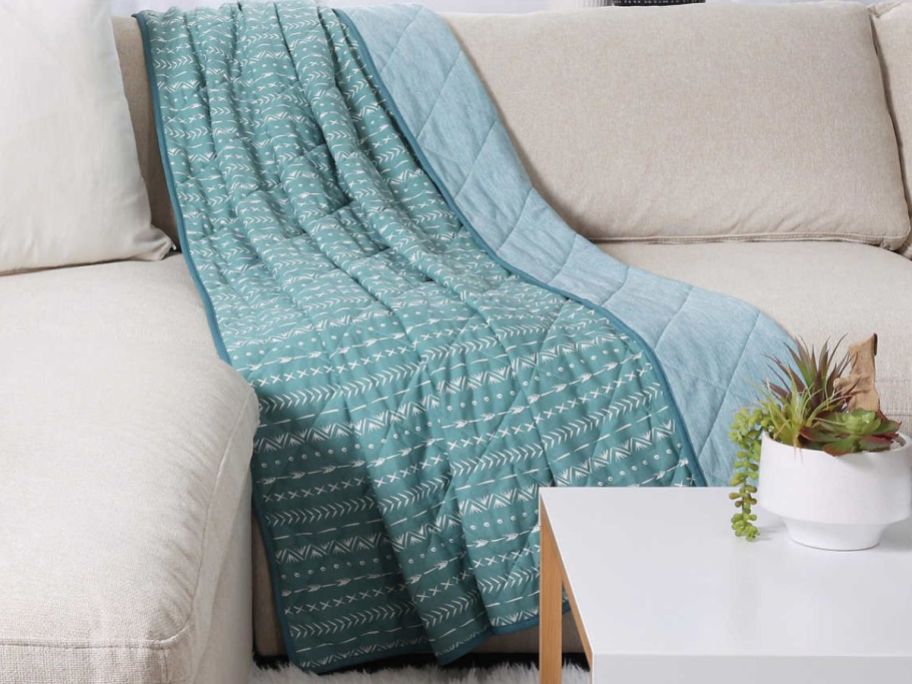 A Life Comfort cooling Throw laid on a couch