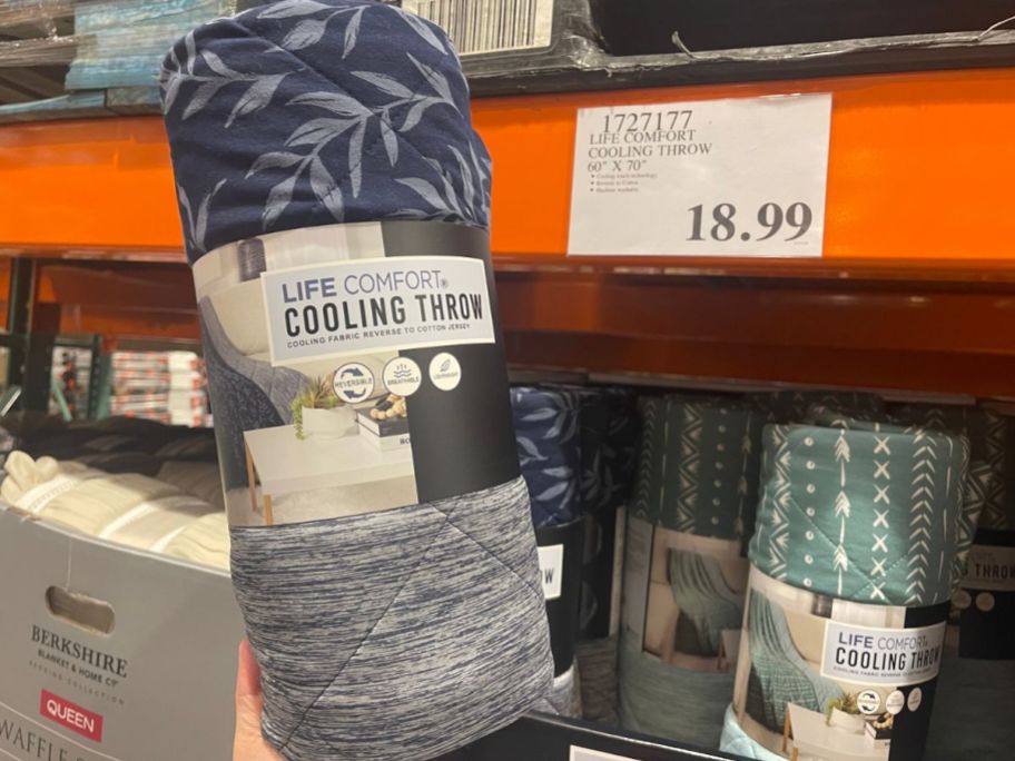 A Life Comfort Cooling Throw Blanket next to the price sign at Costco
