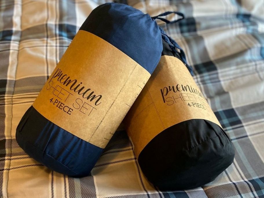 Linens & Hutch Sheets blue and black in package on bed 