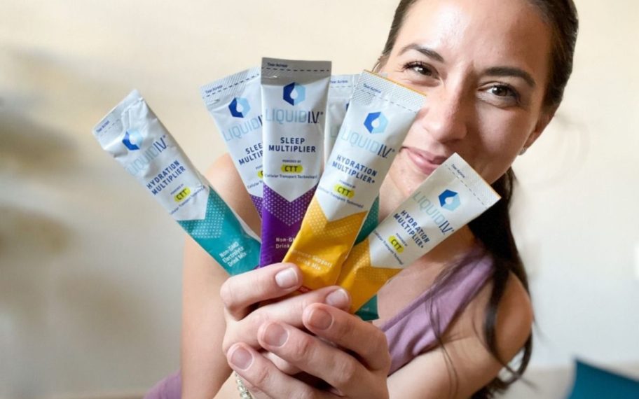 Woman holding liquid IV packet