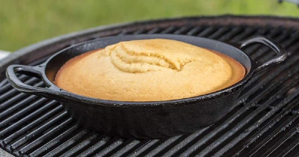 cornbread in round cast iron skillet on grill outside