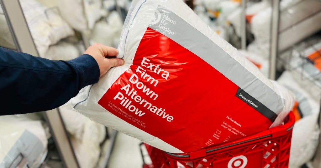 hand putting pillow in red cart 