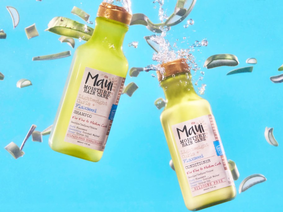 bottles of Maui Moisture Flaxseed Shampoo & Conditioner dropping into water
