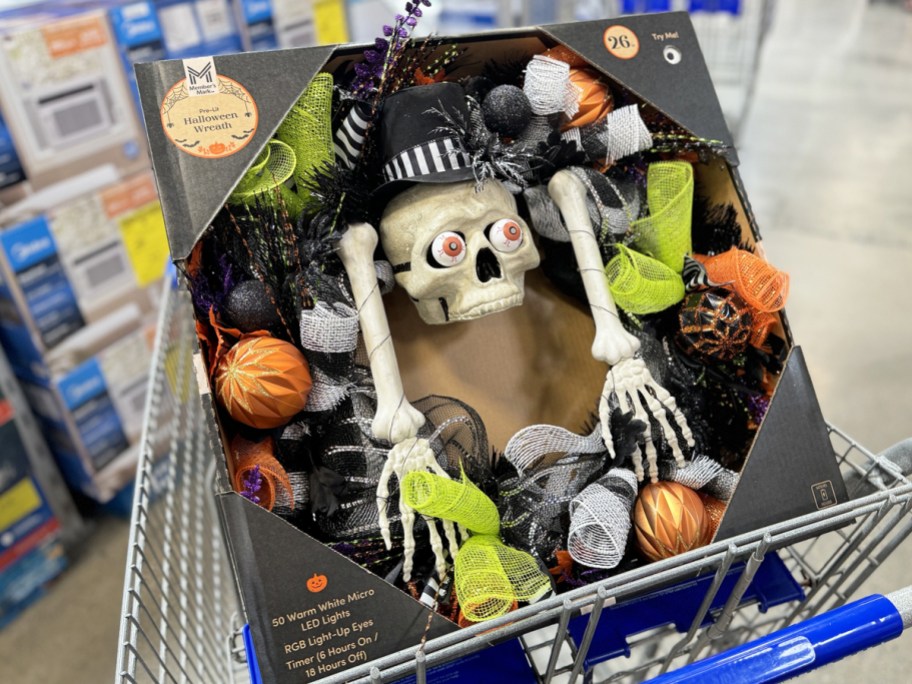 black halloween wreath with skeleton in center in shopping cart