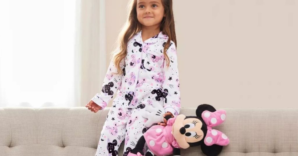 Little girl with Minnie Mouse PLush wearing pajamas