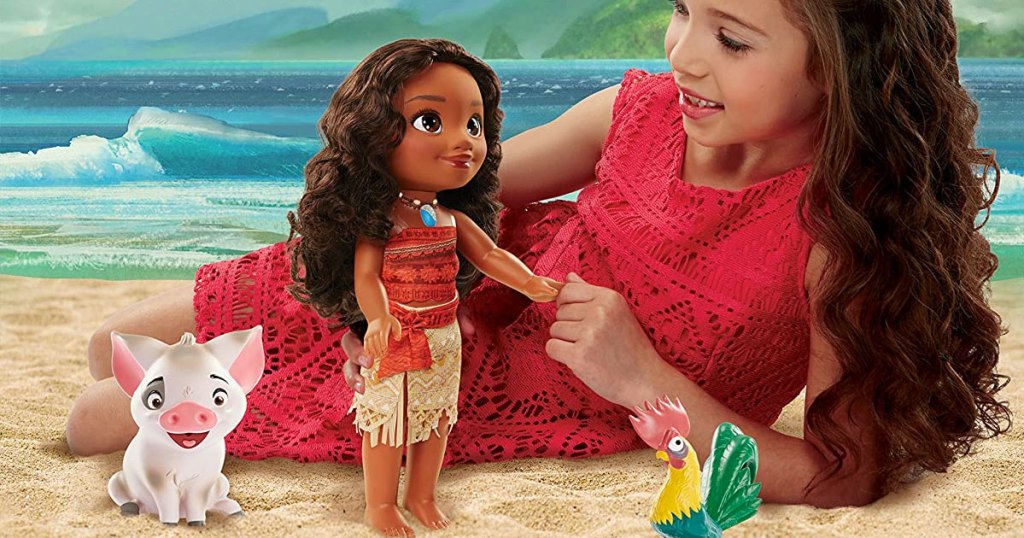 girl playing with moana doll