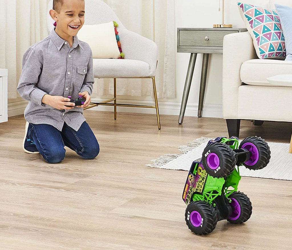 boy playing with RC monster truck doing wheelie