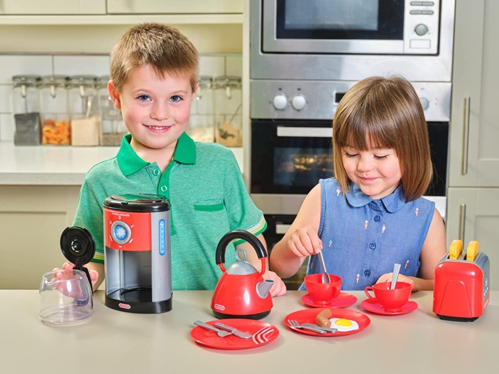 boy and girl playing with kitchen playset in kitchen