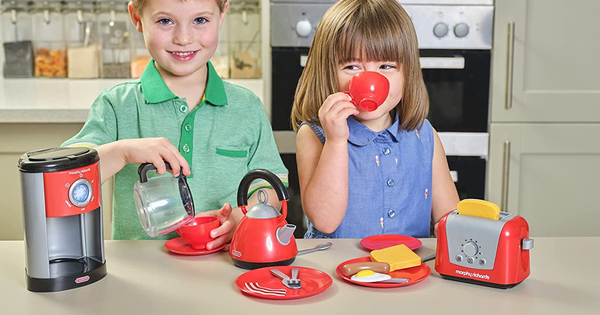 boy and girl playing with kitchen playset in kitchen