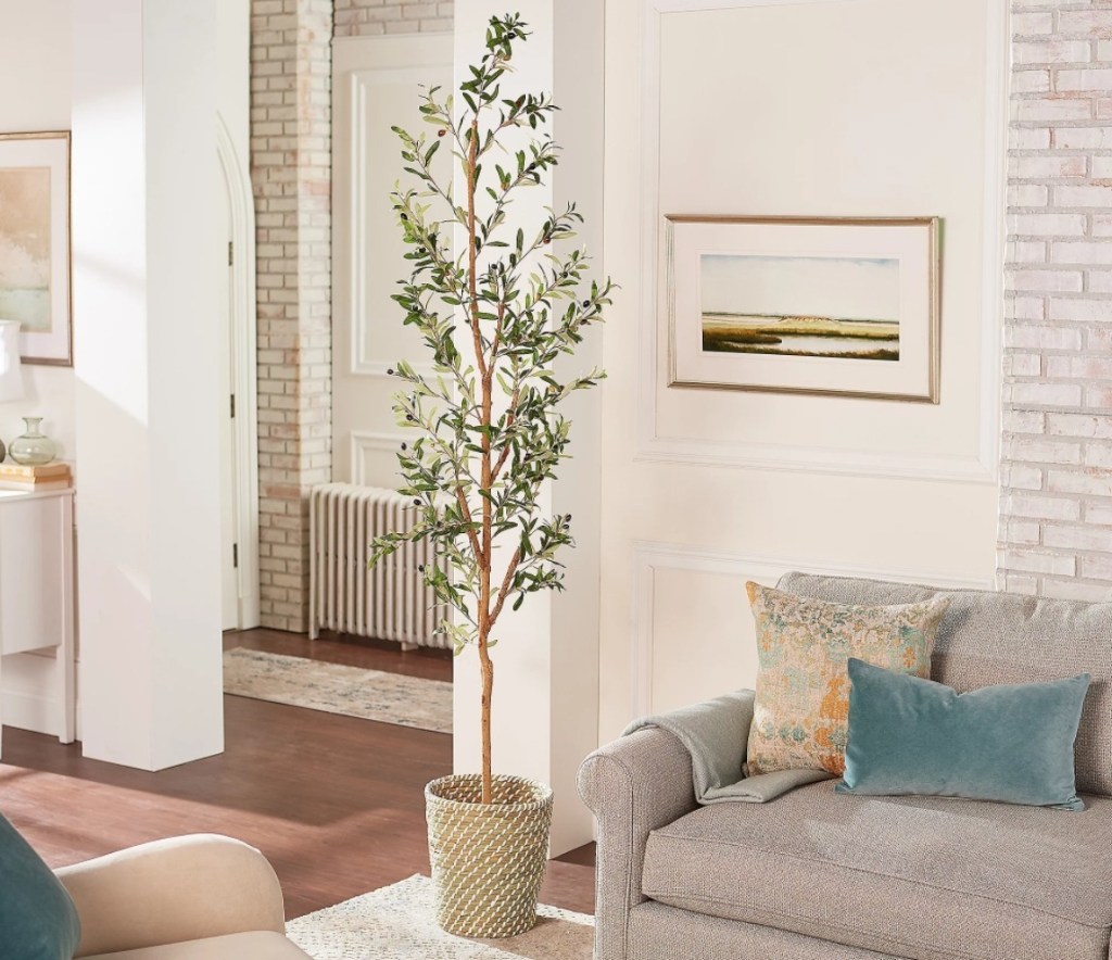 Nearly Natural Artificial Olive Tree next to a couch