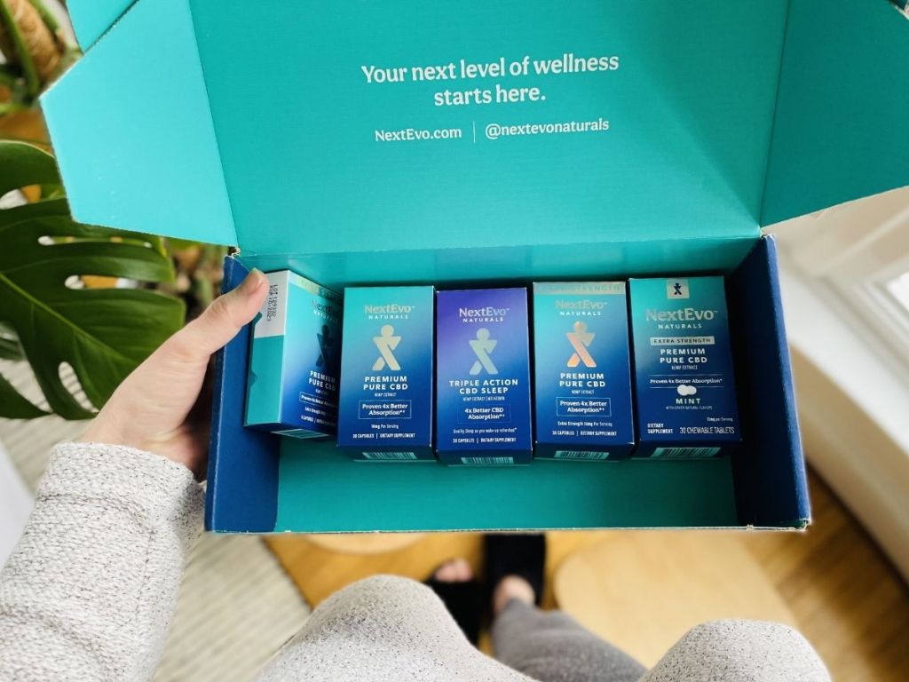 hands holding box filled with NextEvo products