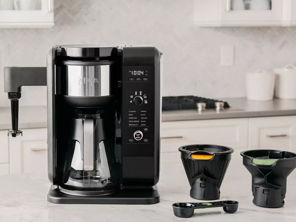 hot and cold coffee and tea maker and accessories on kitchen counter