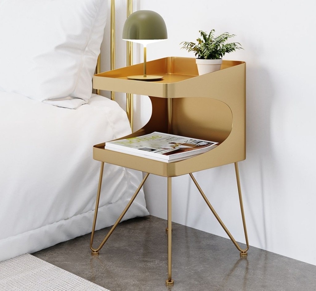 gold nightstand by a bed