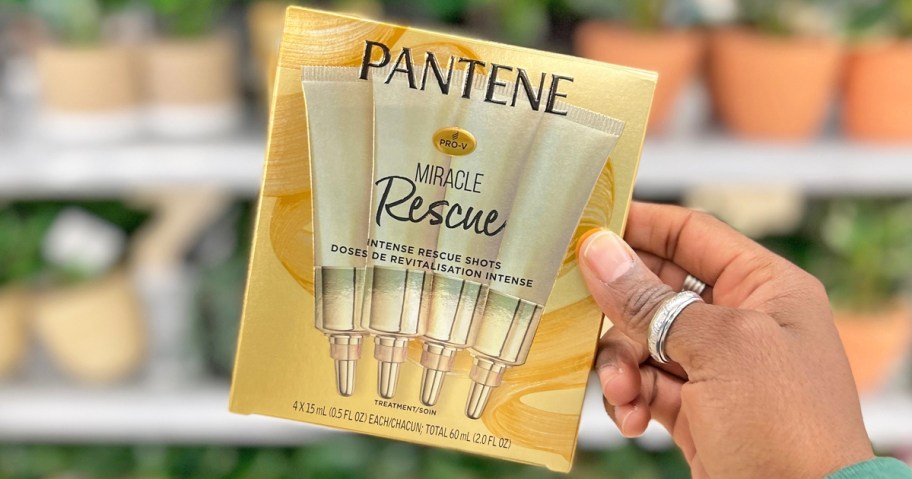hand holding a pack of Pantene Miracle Rescue Intense Rescue Shots in store