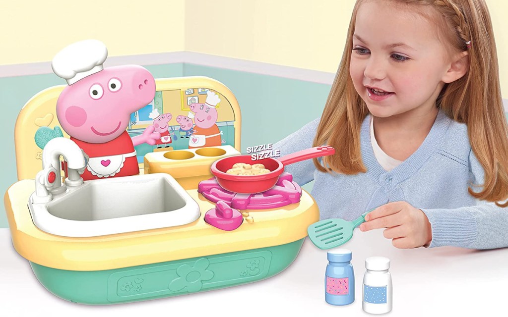 little girls playing with a Peppa Pig Cooking Fun Tabletop Kitchen