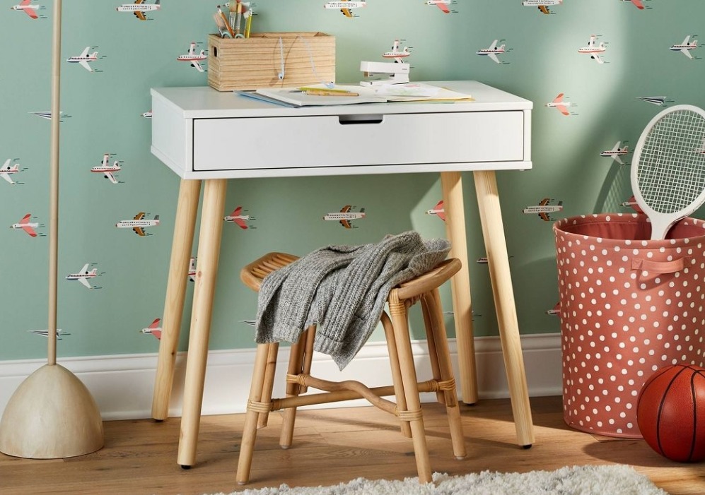 kids desk and chair with a bin next to it