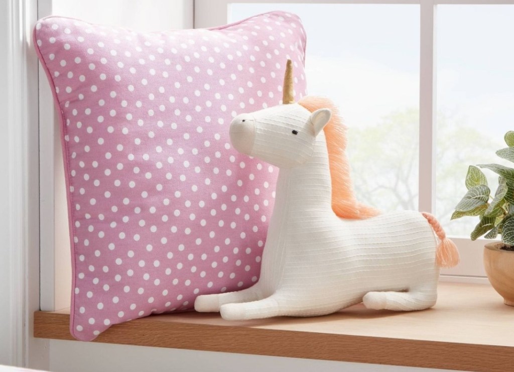 Pillowfort Unicorn Figural Throw Pillow on a shelf