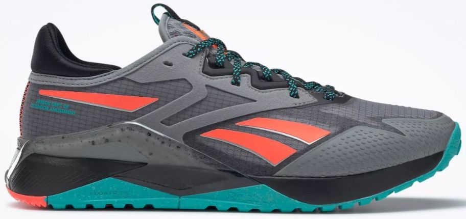 a gray running shoe with orange and aqua colored accents