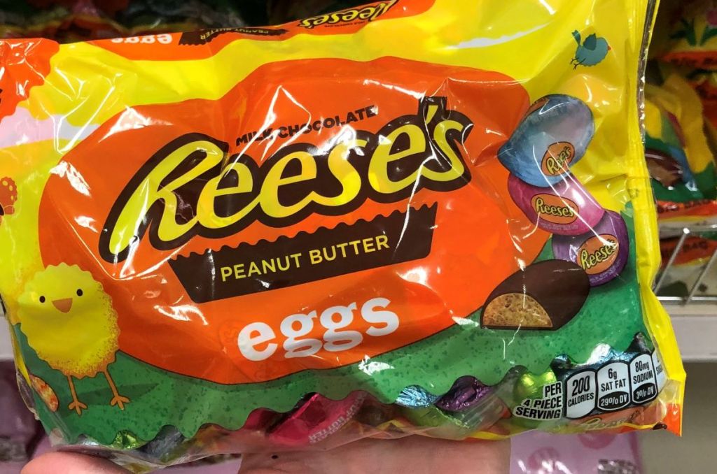 hand holding a bag of Reese's Eggs