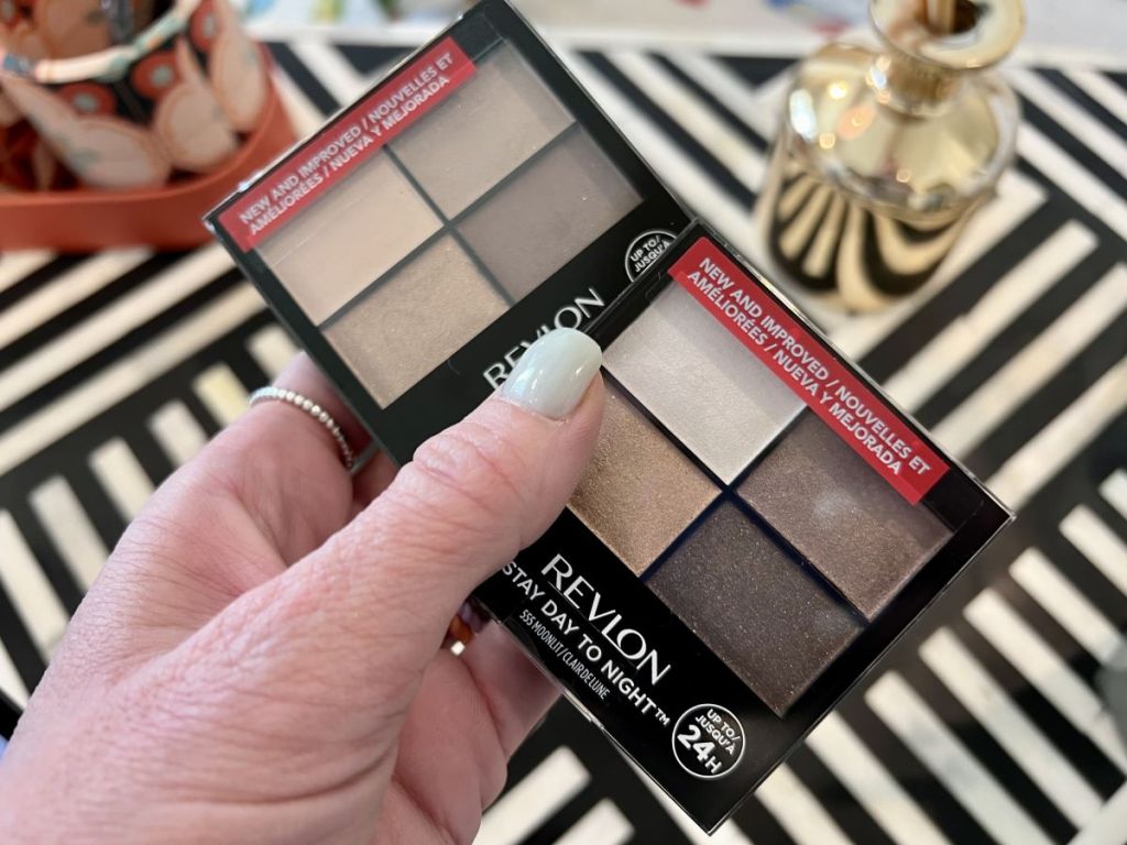 hand holding two Revlon Eyeshadow Quads