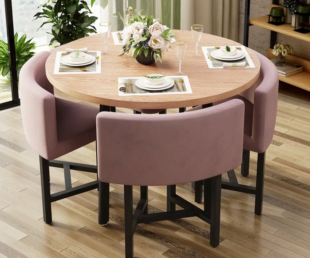 round dining table with pink nesting chairs